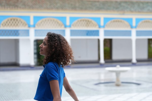 Example image of a female model facing left in colourful courtyard