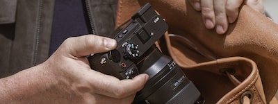 Usage image of a user taking the camera out of a bag