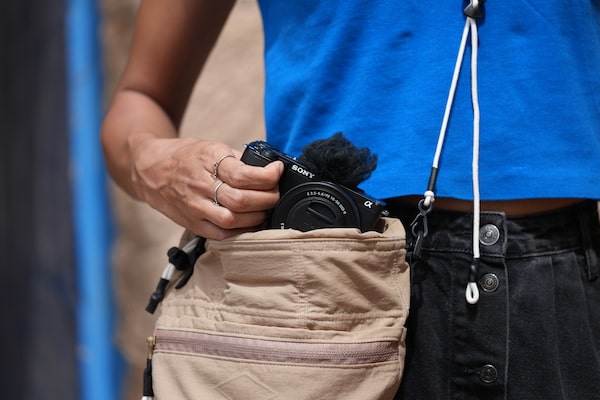 Usage image of a man taking the camera out of a bag